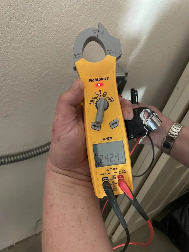 Voltage testing with clamp meter during Recessed Lighting Installation in La Grange